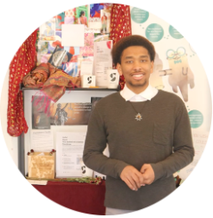 Kendal Liverpool smiling in front of his shelf at Shift Retail Lab.