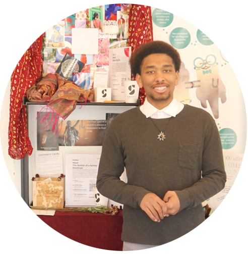 Kendal Liverpool smiling in front of his shelf at Shift Retail Lab.